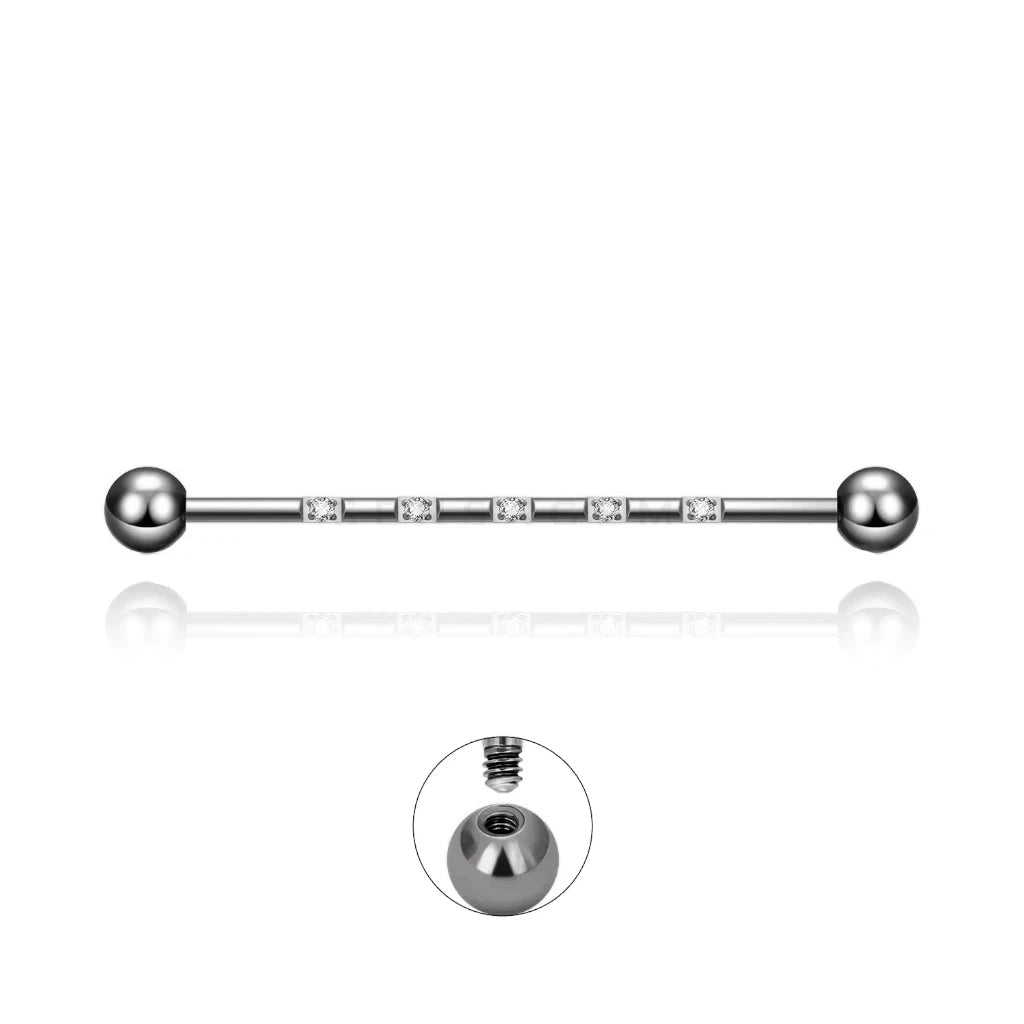 Barre piercing industriel Isidora en titane argenté avec cristaux de zirconium, fermeture en pas de vis externe.