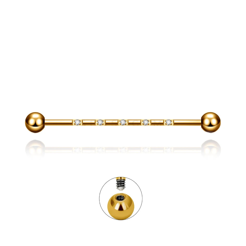 Barre piercing industriel Isidora en titane doré avec cristaux de zirconium, fermeture en pas de vis externe.